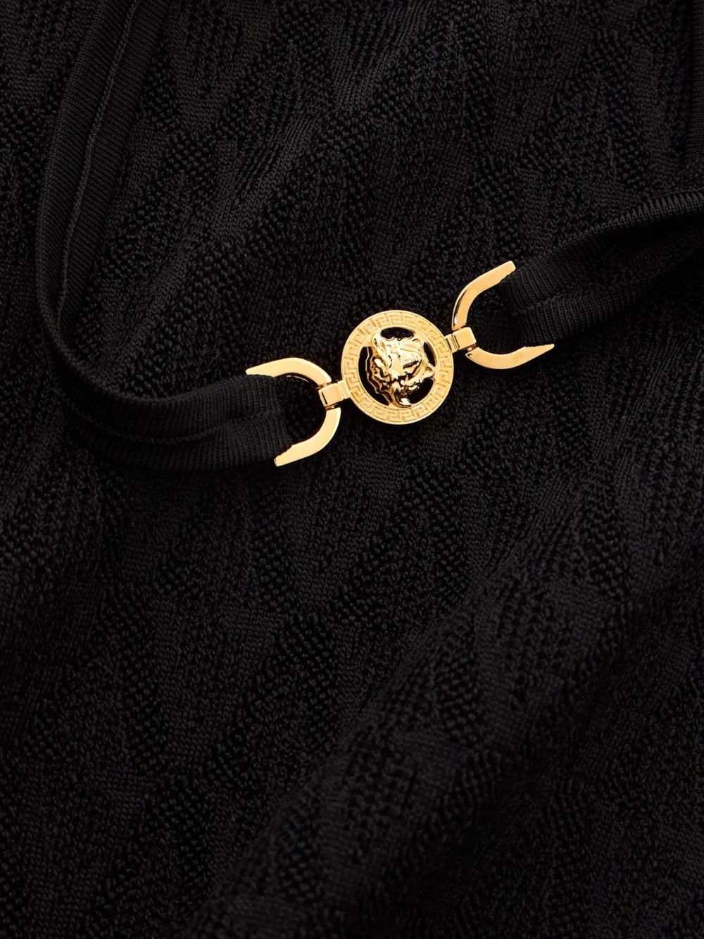 Close-up detail of the Versace Embellished Knitted Midi Dress