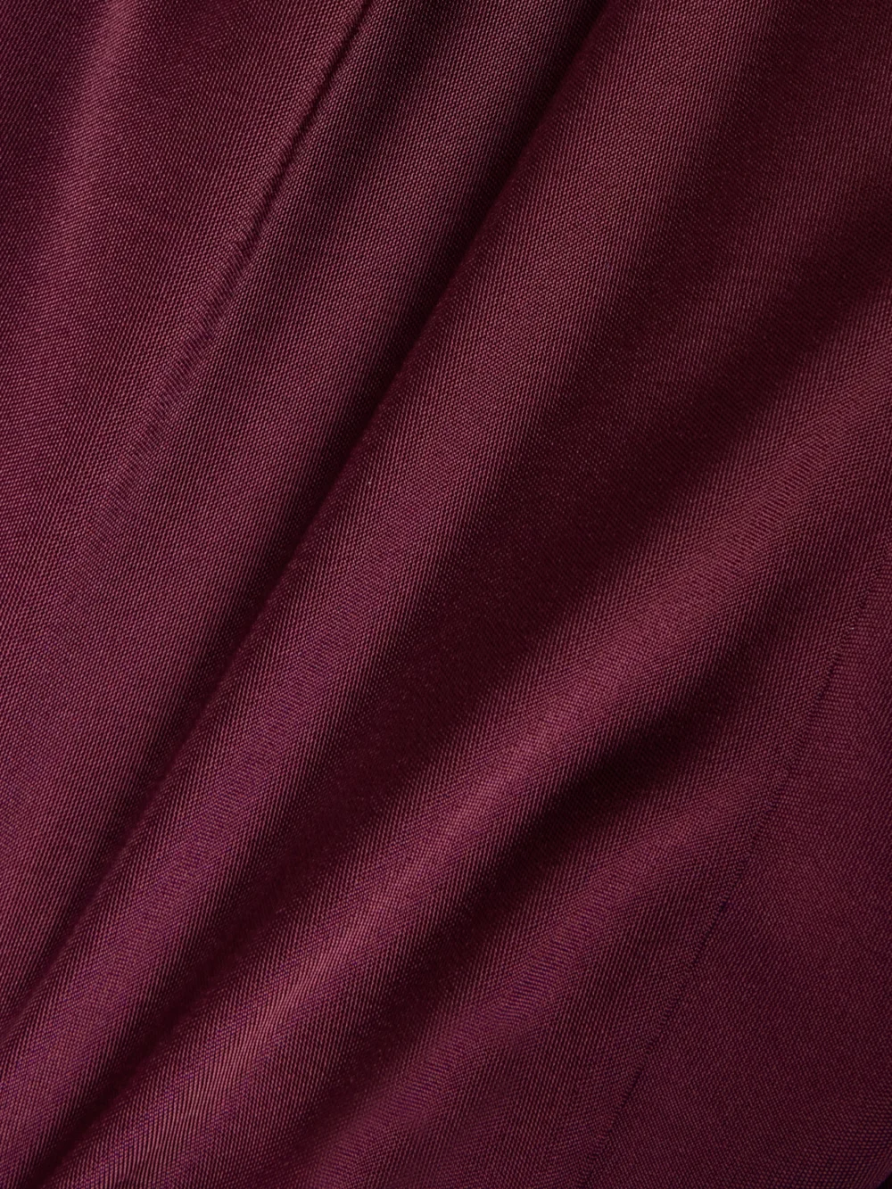 Close-up detail of the Versace Embellished Paneled Draped Satin-jersey Gown