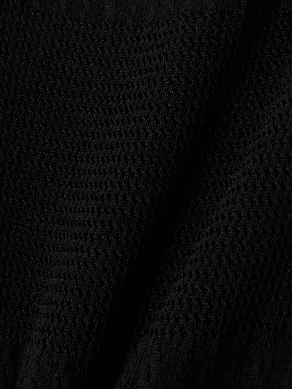 Close-up detail of the Versace Embellished Ruffled Cable-knit Wool-blend Mini Dress