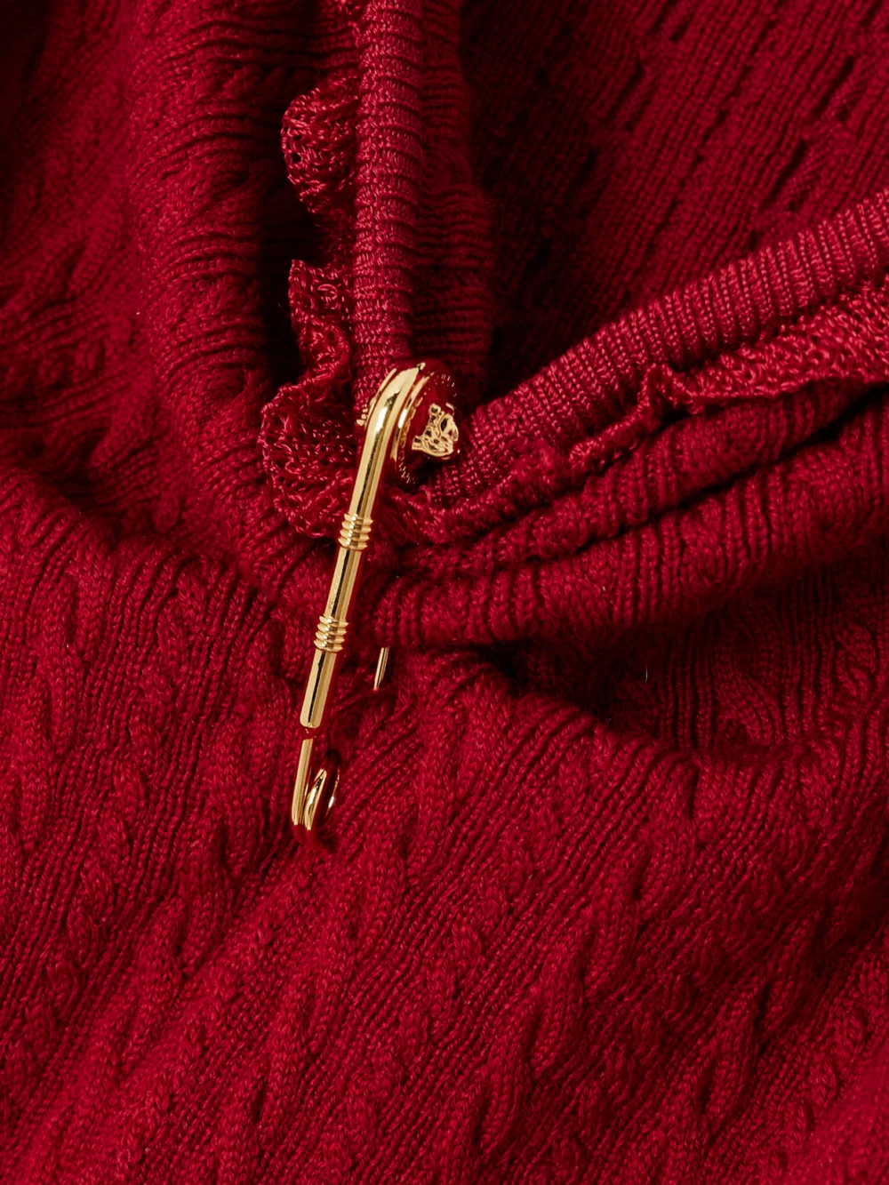 Close-up detail of the Versace Embellished Ruffled Cable-knit Wool-blend Mini Dress