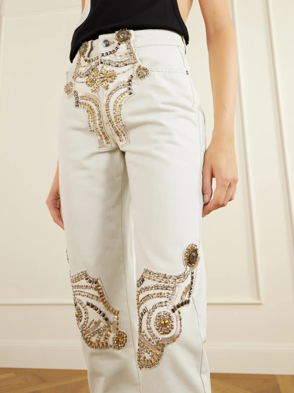 Close-up detail of the Versace Embellished Straight-leg Jeans