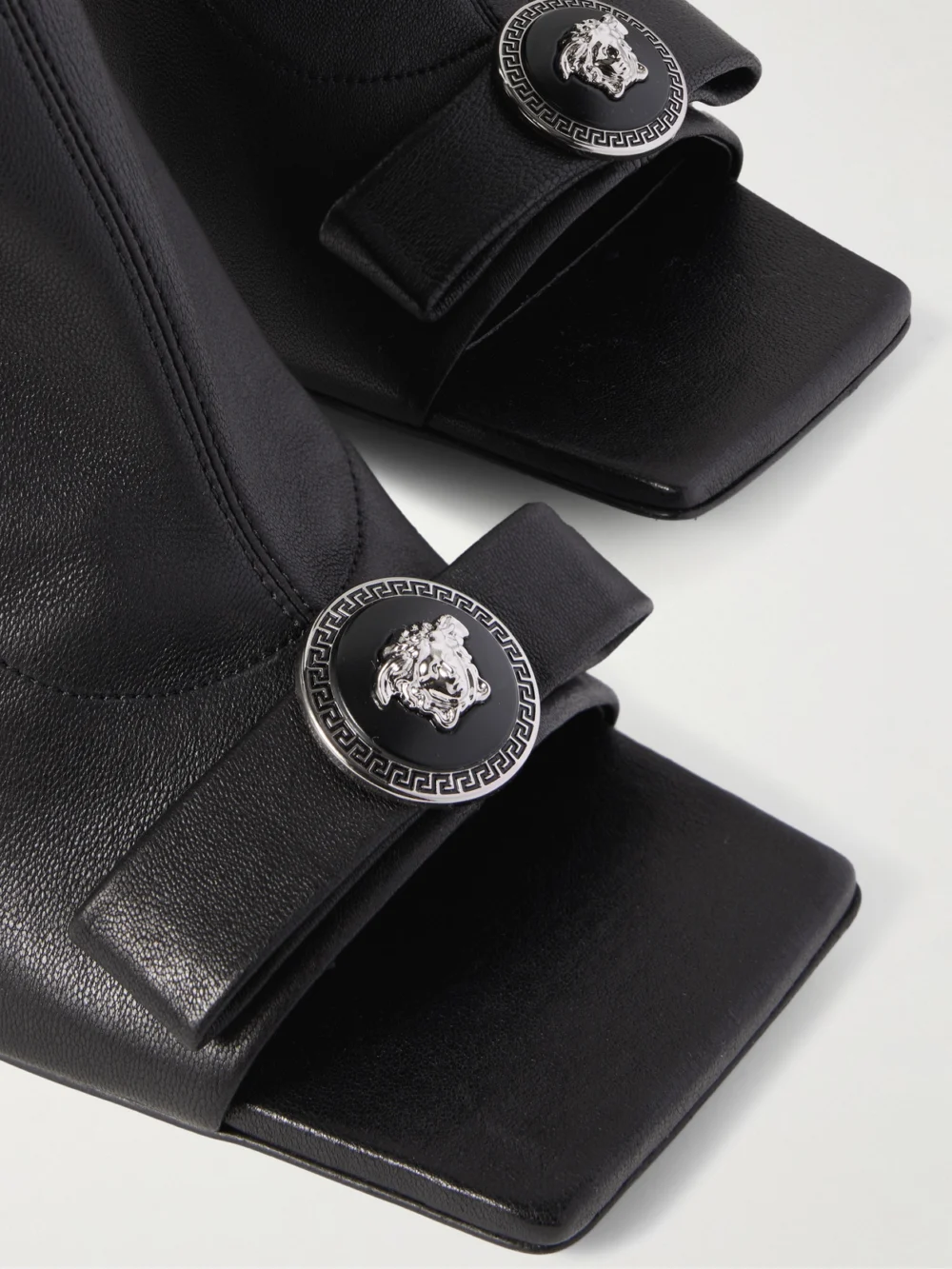 Close-up detail of the Versace Gianni Ribbon Embellished Leather Ankle Boots