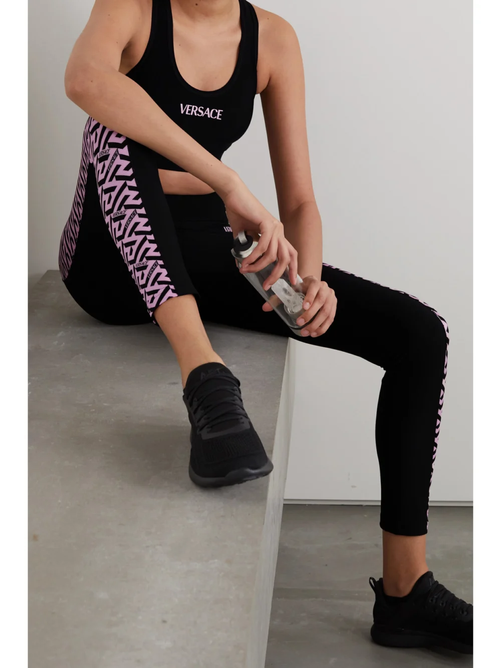 Versace La Greca Printed Stretch Sports Bra, worn by a model
