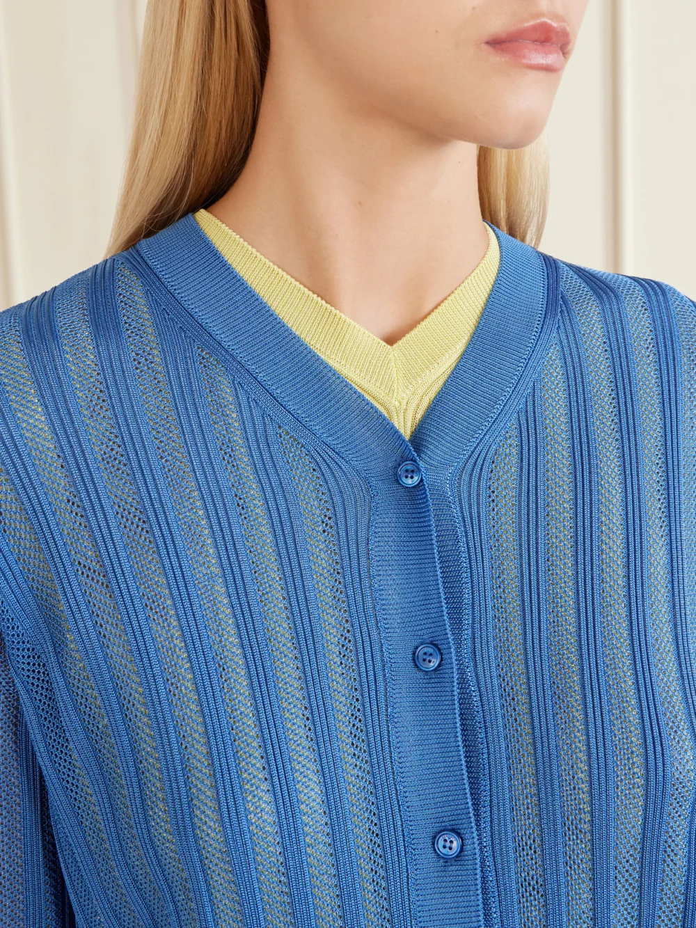 Close-up detail of the Versace Medusa-embellished Ribbed Crochet-knit Cardigan