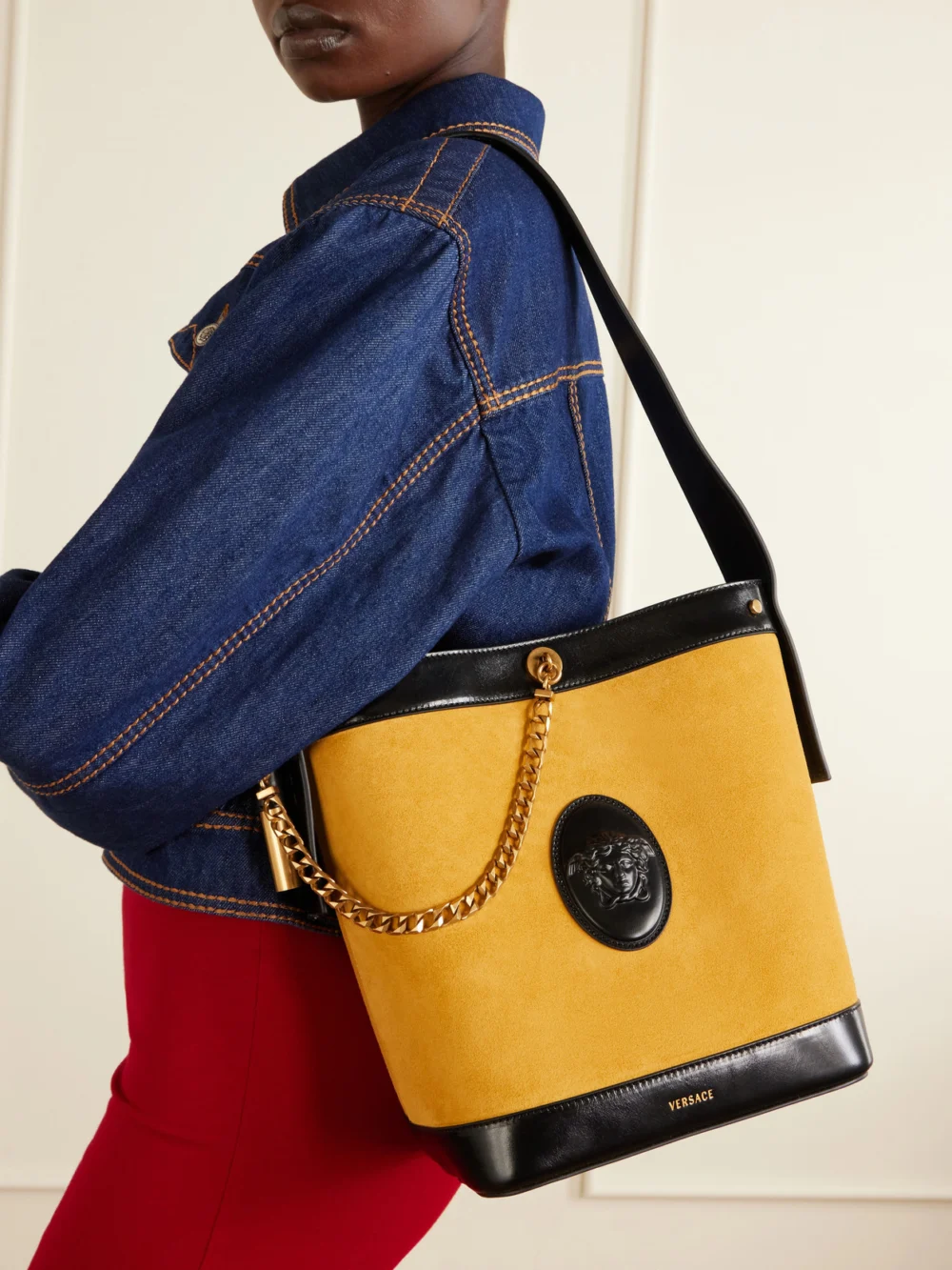 Versace Pivot Logo-appliquéd Small Leather Bucket Bag, styled view