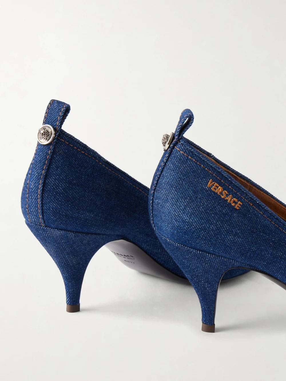Close-up detail of the Versace Tina 65 Medusa-embellished Denim Pumps