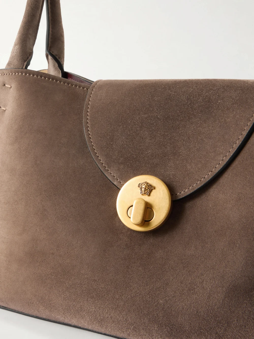 Close-up detail of the Versace Vivienne Logo-embellished Suede Shoulder Bag