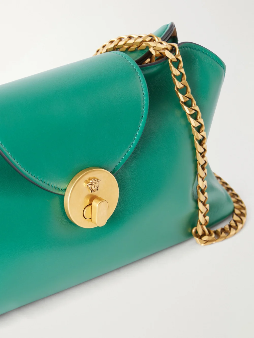 Close-up detail of the Versace Vivienne Medusa-detailed Leather Clutch