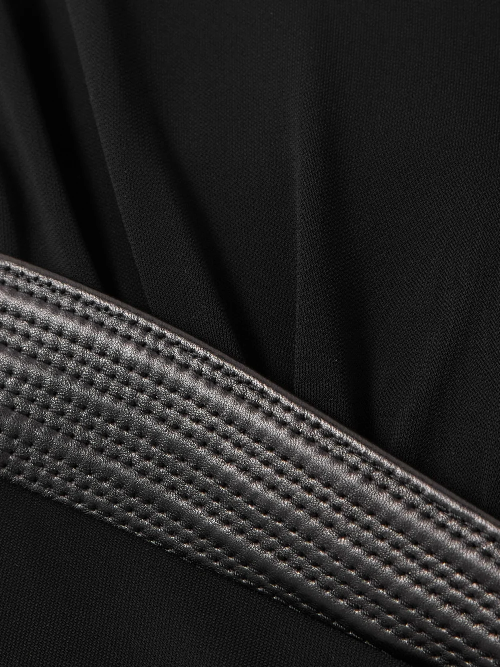 Close-up detail of the Versace Wrap-effect Leather-trimmed Crepe-jersey Bodysuit