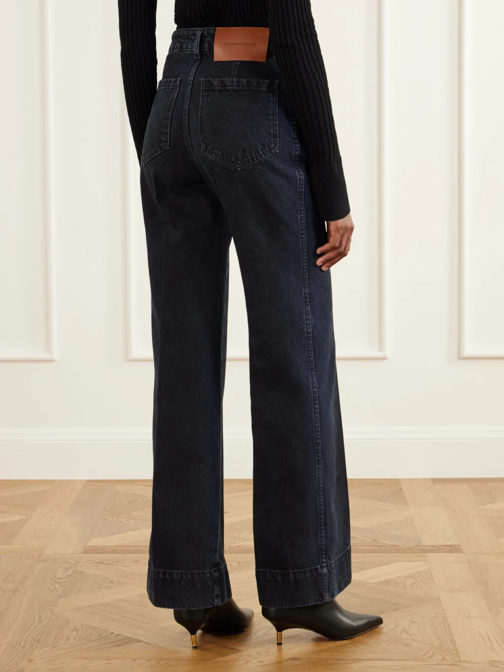 Back view of the Victoria Beckham Alina Logo-embroidered High-rise Flared Jeans