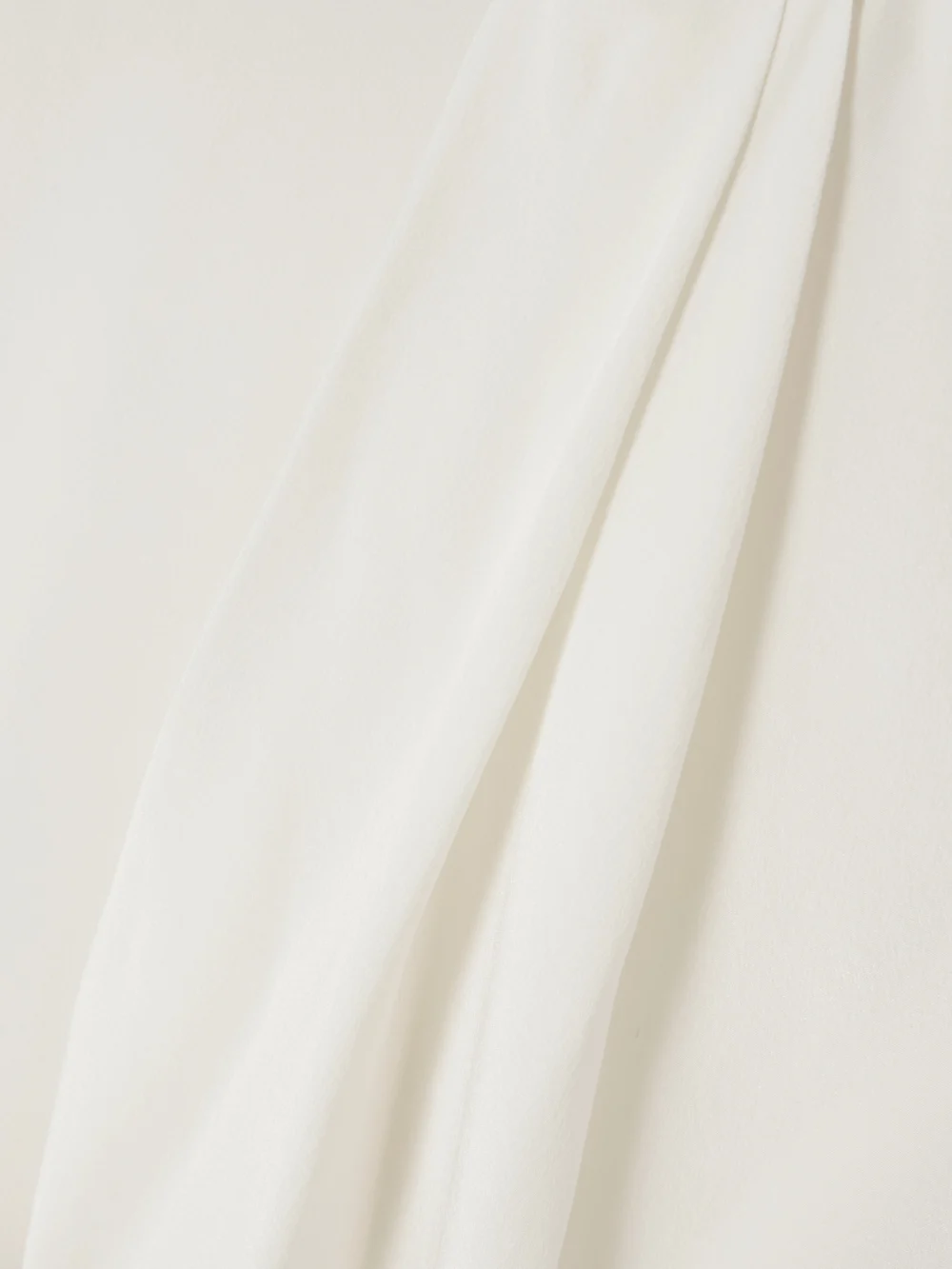 Close-up detail of the Victoria Beckham Asymmetric Draped Silk Blouse