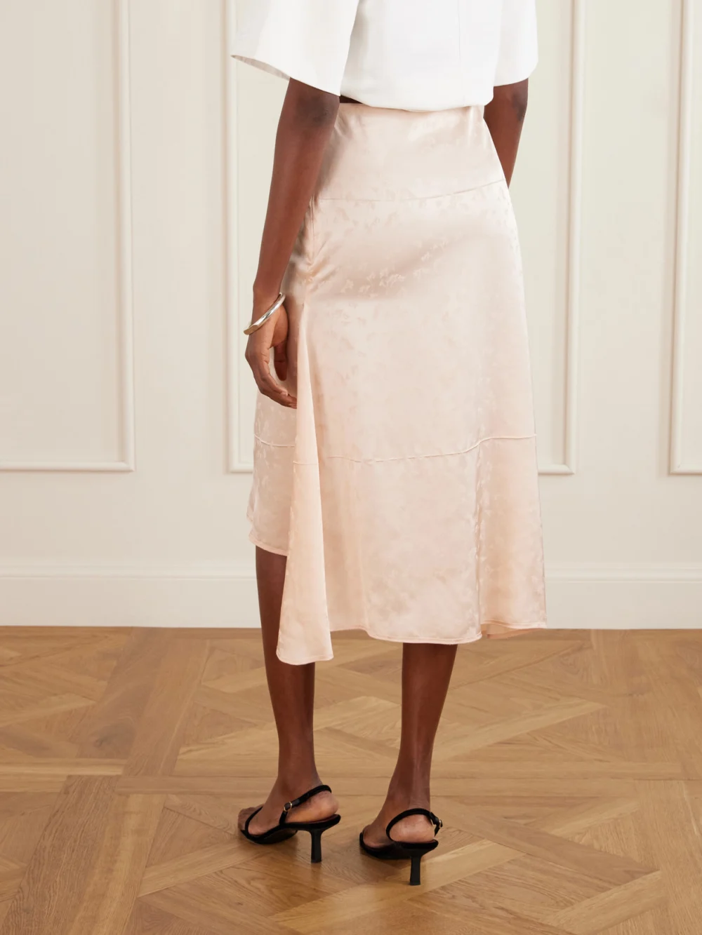 Back view of the Victoria Beckham Asymmetric Floral-jacquard Satin Midi Skirt