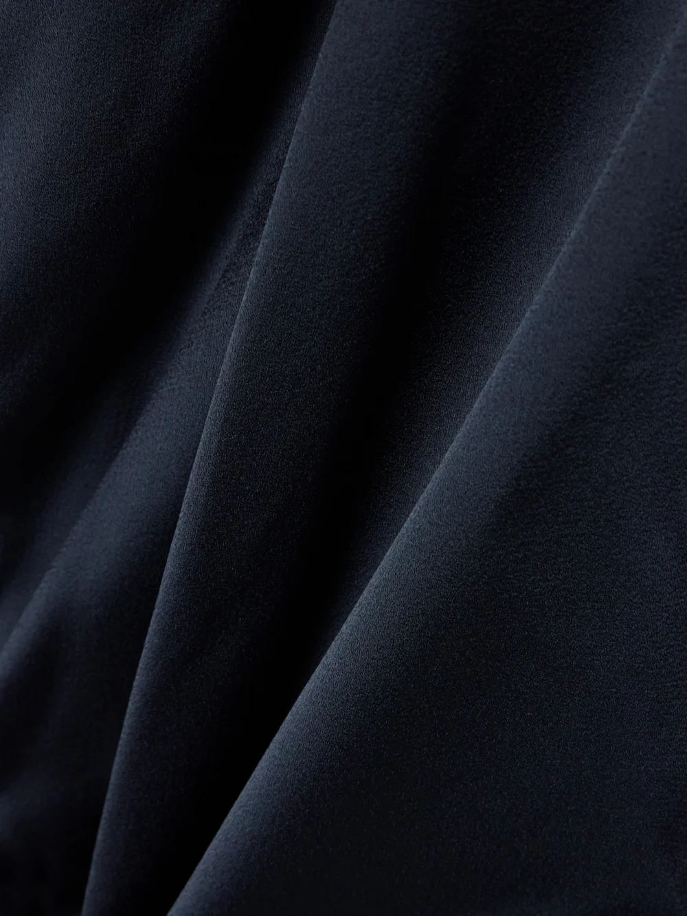 Close-up detail of the Victoria Beckham Chain-embellished Draped Satin Halterneck Gown