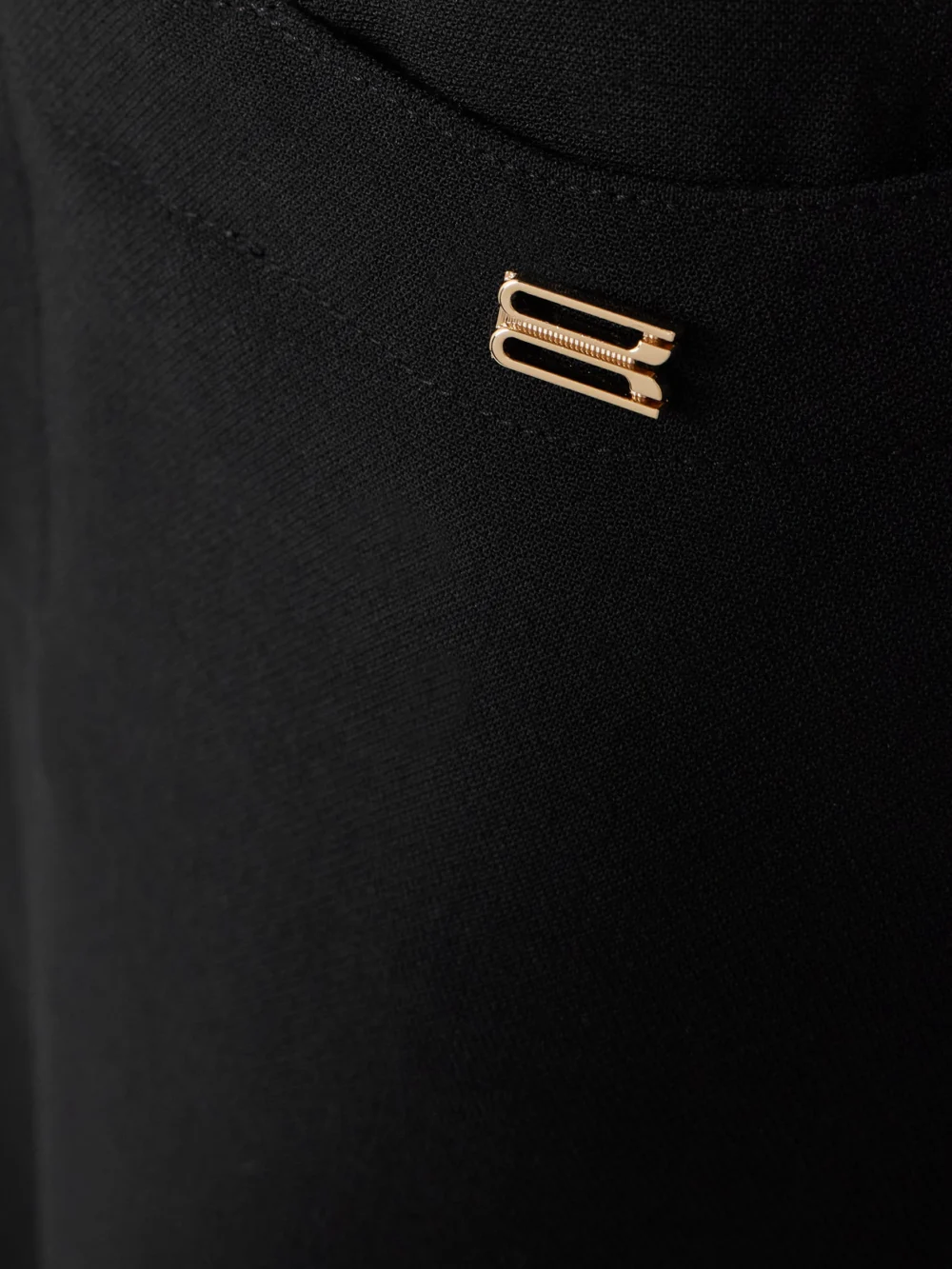 Close-up detail of the Victoria Beckham Cropped Crepe Flared Pants