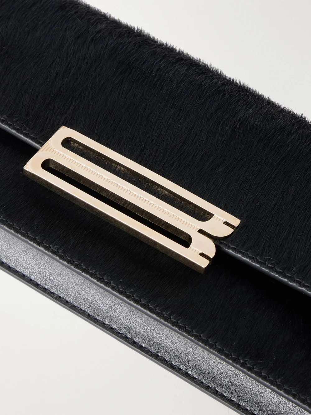 Close-up detail of the Victoria Beckham Dorian East-west Calf Hair Clutch
