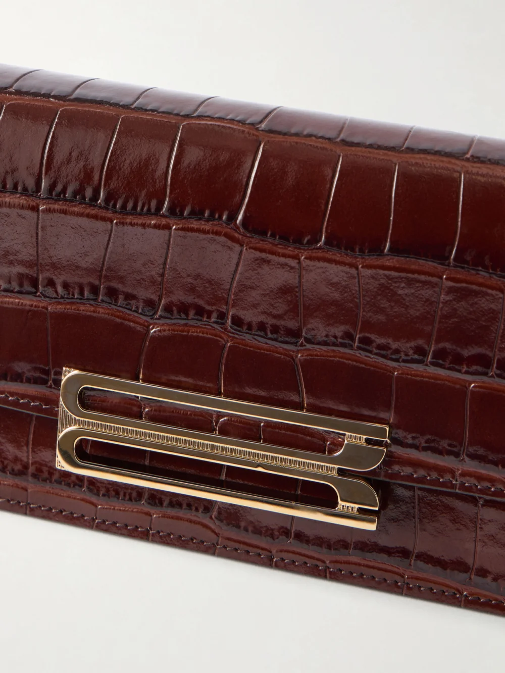 Close-up detail of the Victoria Beckham Dorian East-west Croc-effect Leather Clutch