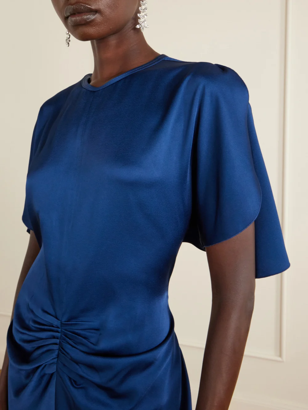 Close-up detail of the Victoria Beckham Isabella Ruched Satin Gown