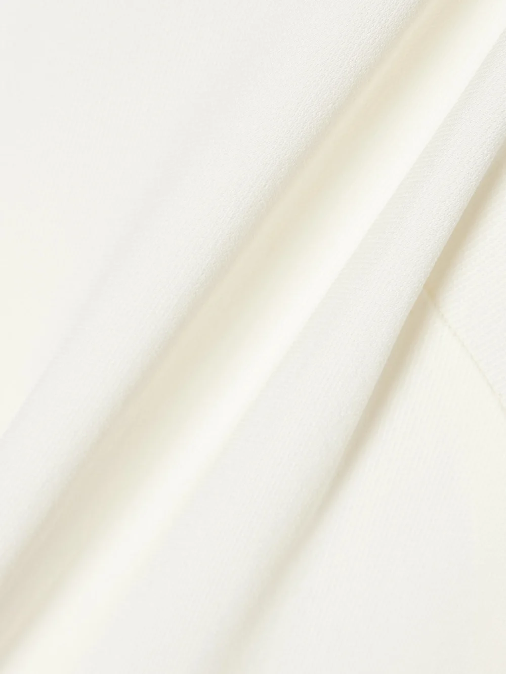 Close-up detail of the Victoria Beckham One-shoulder Open-back Embellished Draped Ribbed-knit Gown