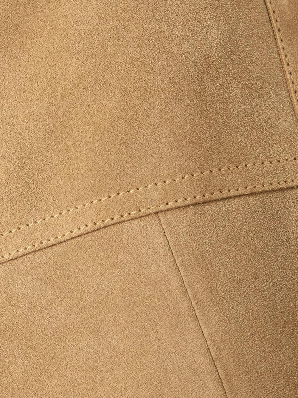Close-up detail of the Victoria Beckham Paneled Suede Midi Skirt