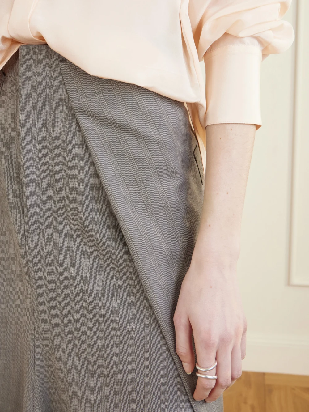 Close-up detail of the Victoria Beckham Pleated Wool Midi Skirt