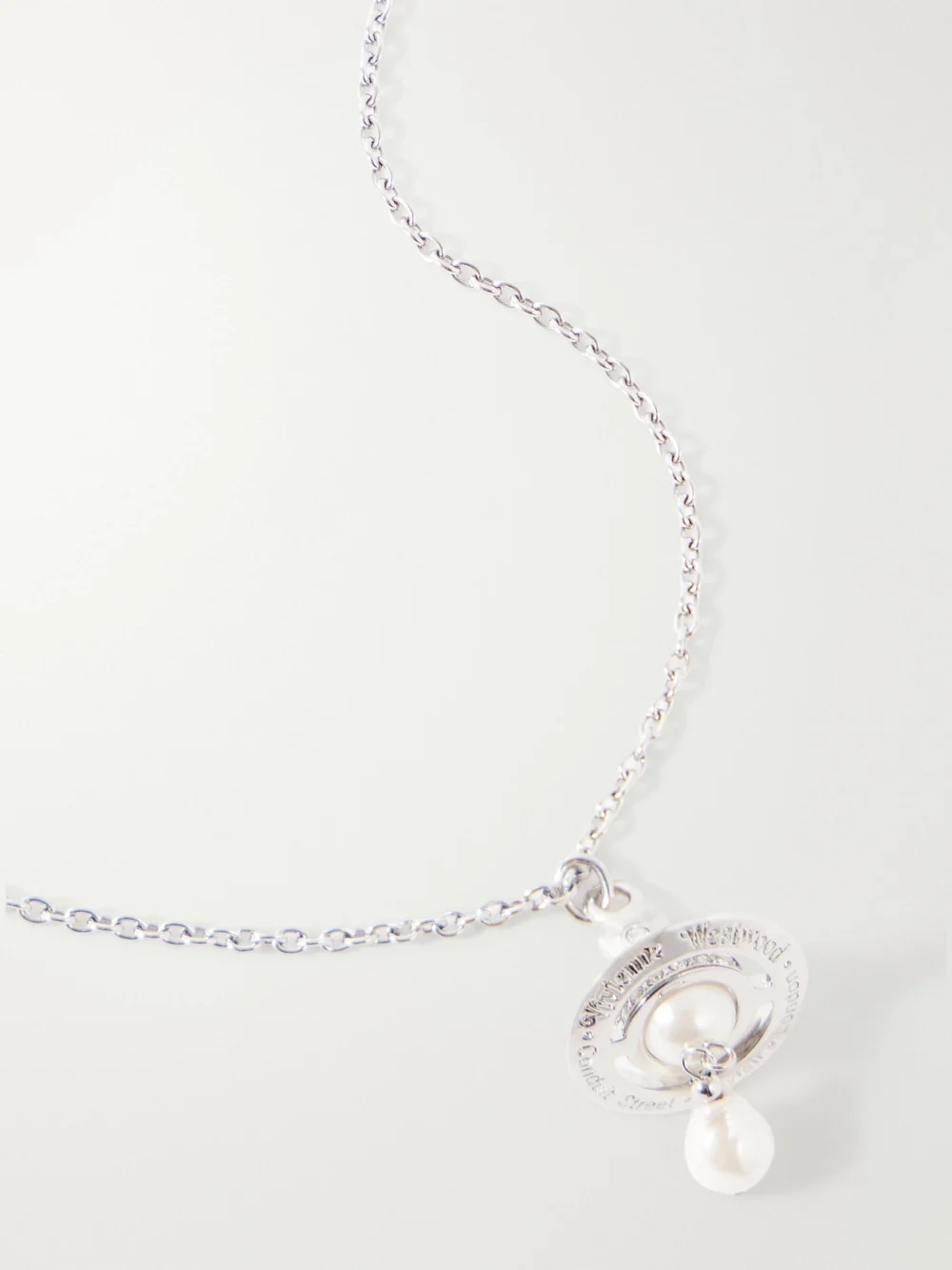 Close-up detail of the Vivienne Westwood Aleksa Orb-detailed Pearl-effect Silver-tone Necklace