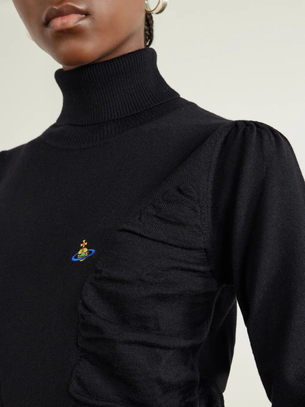 Close-up detail of the Vivienne Westwood Pamela Logo-embroidered Gathered Wool Turtleneck Sweater