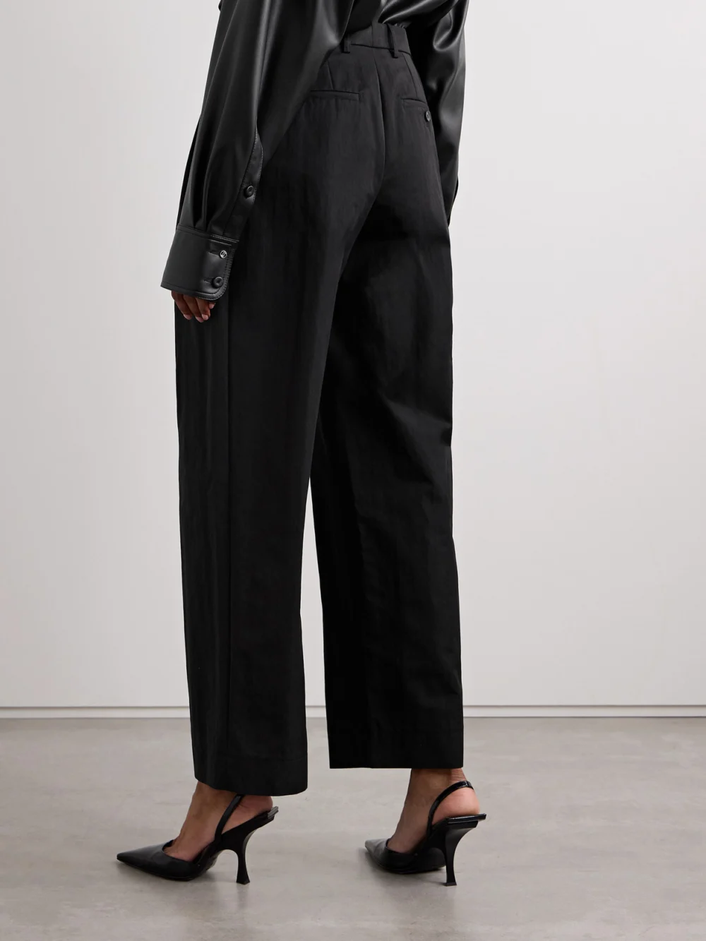 Back view of the WARDROBE.NYC Pleated Cotton-blend Twill Wide-leg Pants