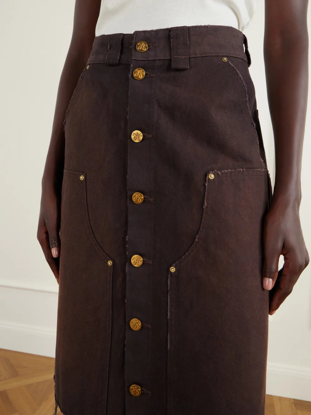 Close-up detail of the Willy Chavarria Workwear Faded Frayed Cotton Duck-canvas Knee-lenght Skirt