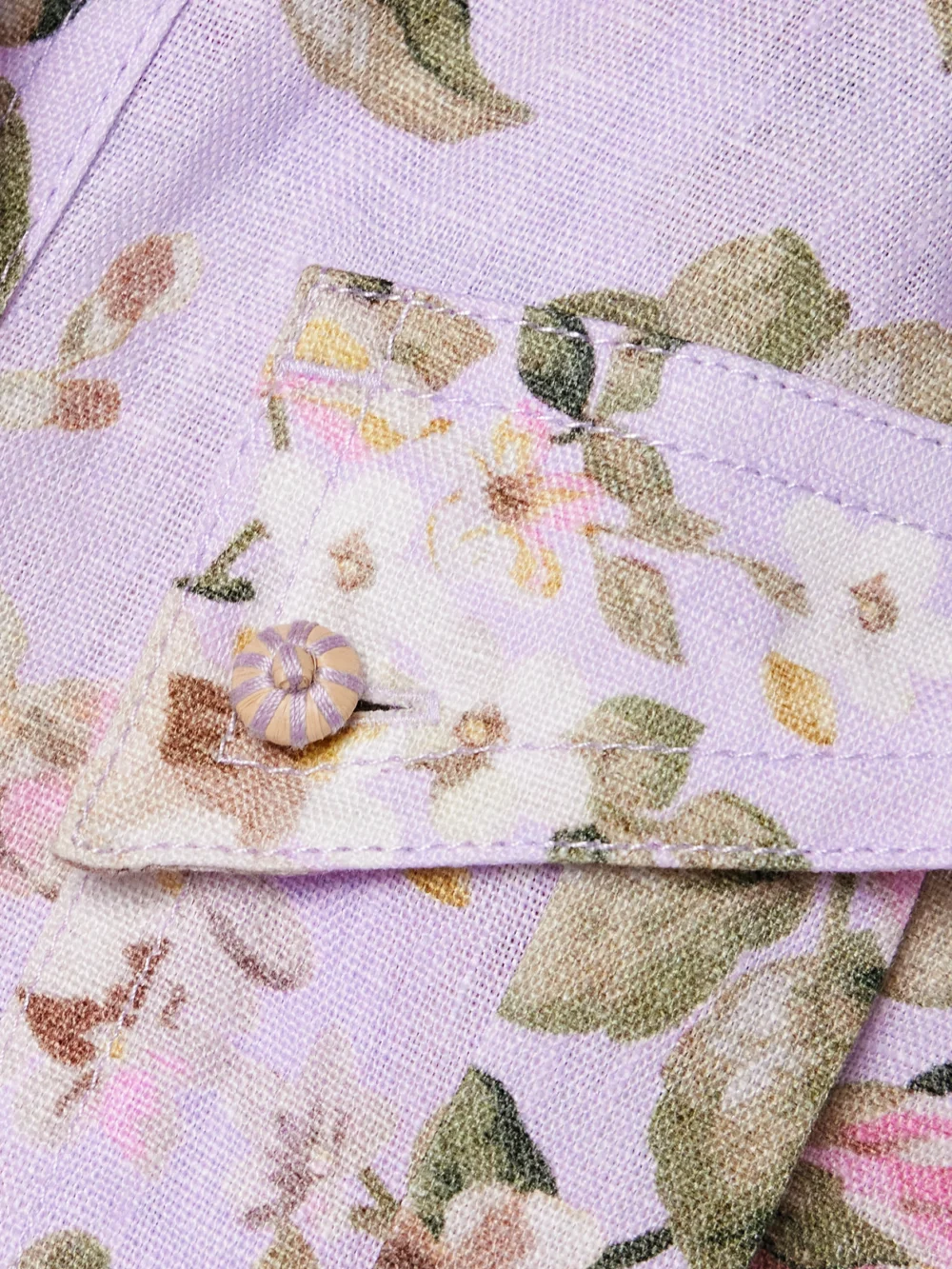Close-up detail of the Zimmermann Acacia Belted Floral-print Linen Playsuit