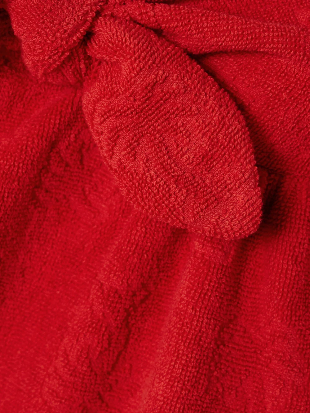 Close-up detail of the Zimmermann Alight Strapless Bow-embellished Cotton-terry Jacquard Mini Dress