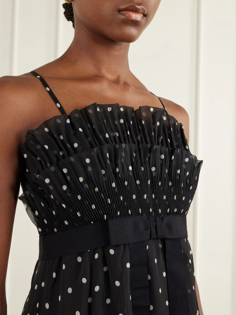 Close-up detail of the Zimmermann Bow-detailed Pleated Ruffled Polka-dot Chiffon Maxi Dress