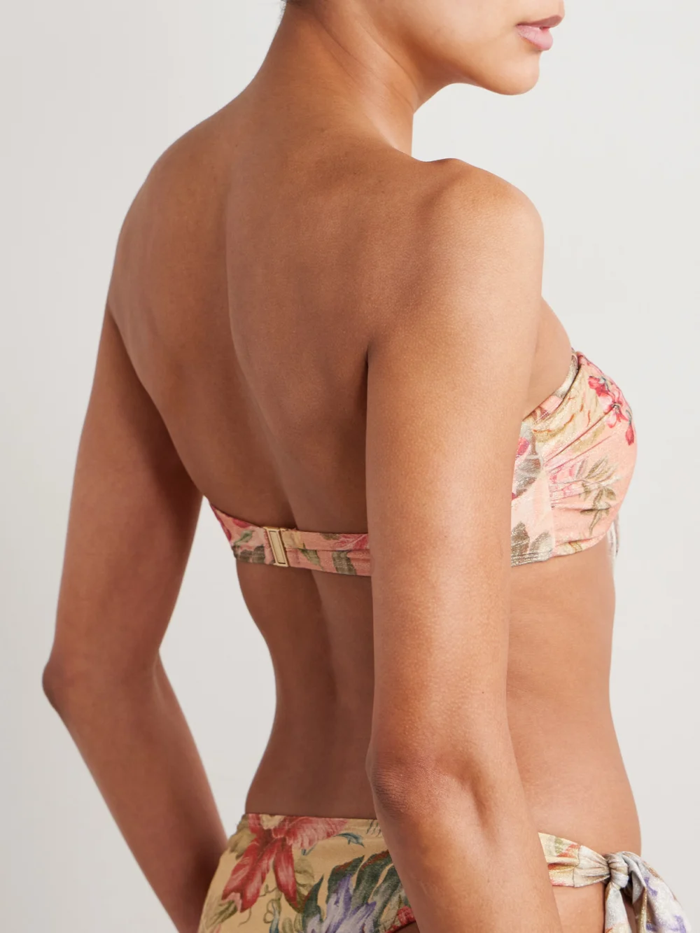 Back view of the Zimmermann Coco Tie-detailed Floral-print Metallic Bandeau Bikini Top