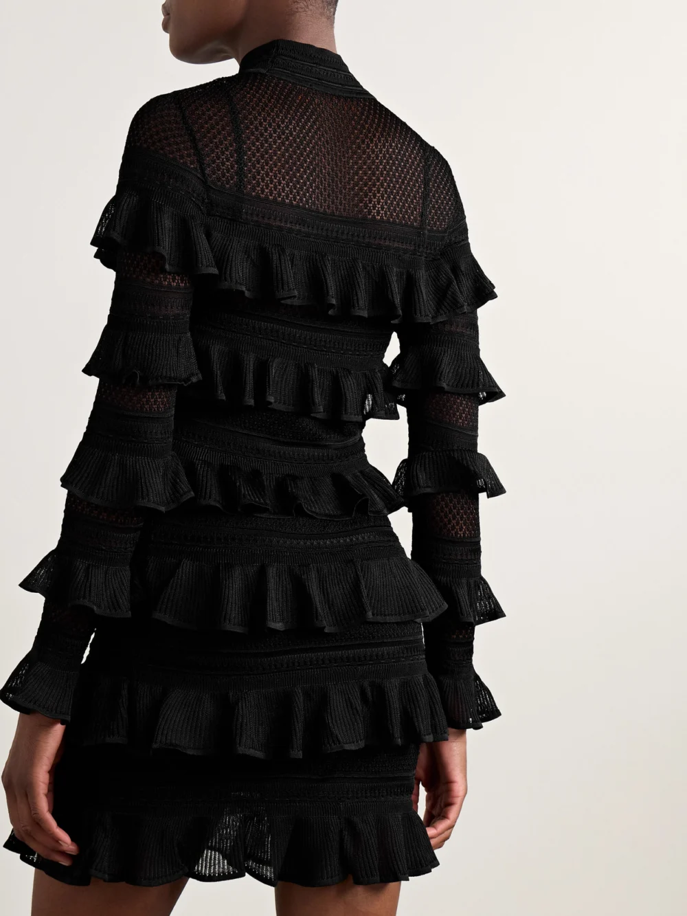 Back view of the Zimmermann Crush Paneled Ruffled Ribbed-knit and Crochet Mini Dress
