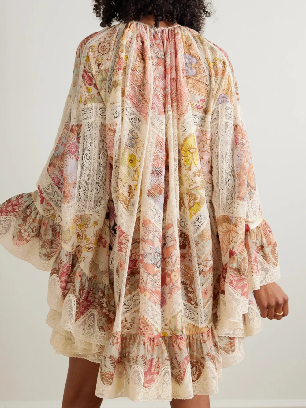 Back view of the Zimmermann Daylight Flutter Lace-trimmed Tiered Printed Cotton Mini Dress
