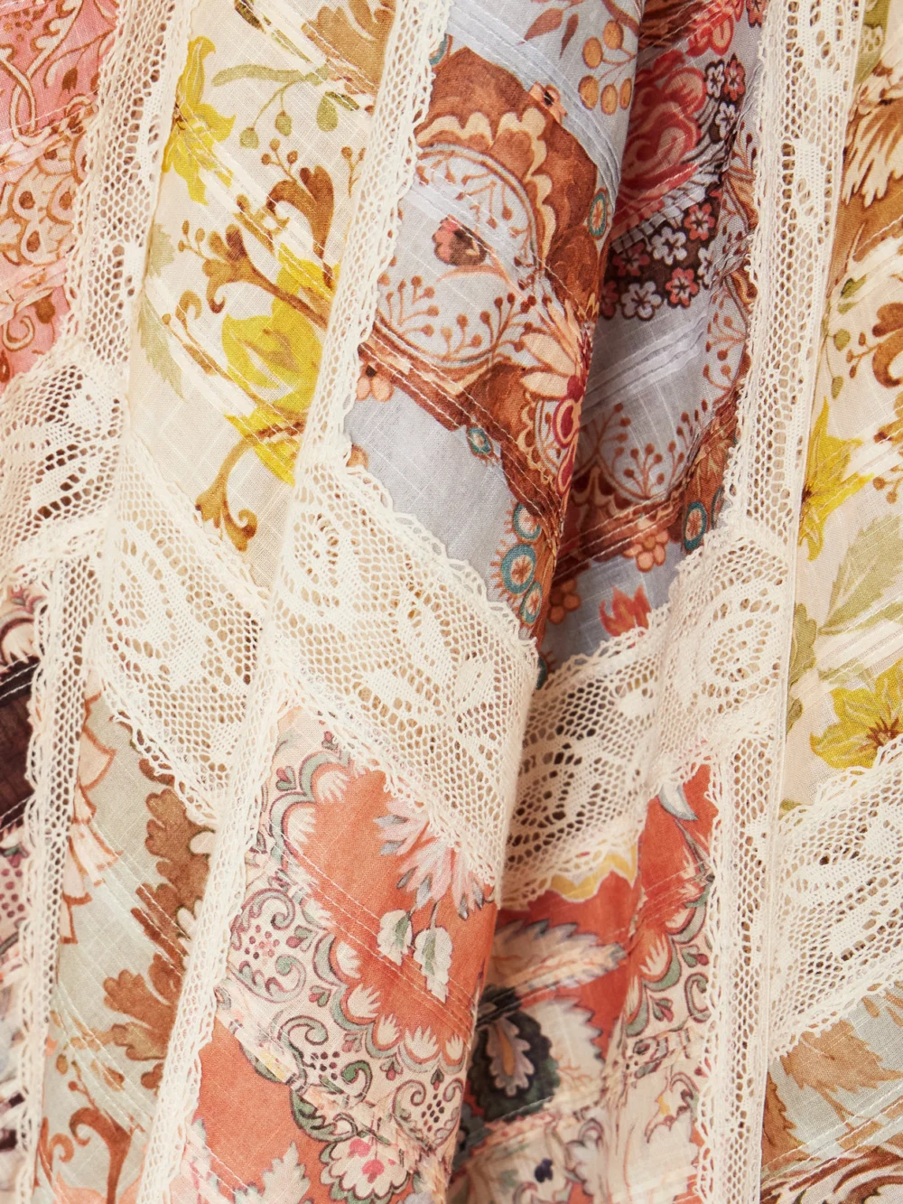 Close-up detail of the Zimmermann Daylight Flutter Lace-trimmed Tiered Printed Cotton Mini Dress
