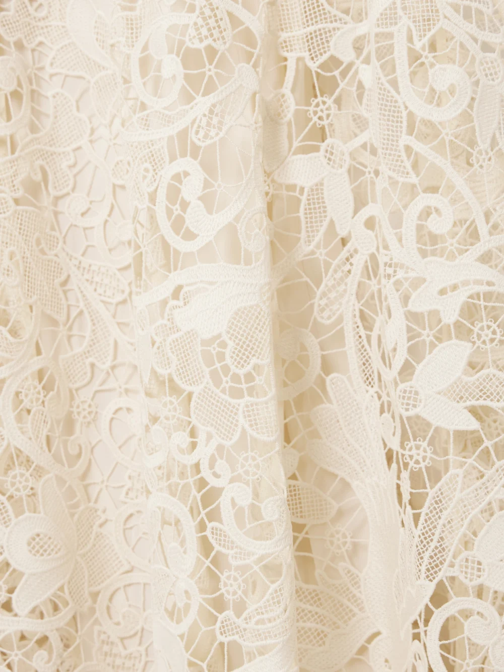 Close-up detail of the Zimmermann Hypnotic Memento Bird Cape-effect Guipure Lace Midi Dress