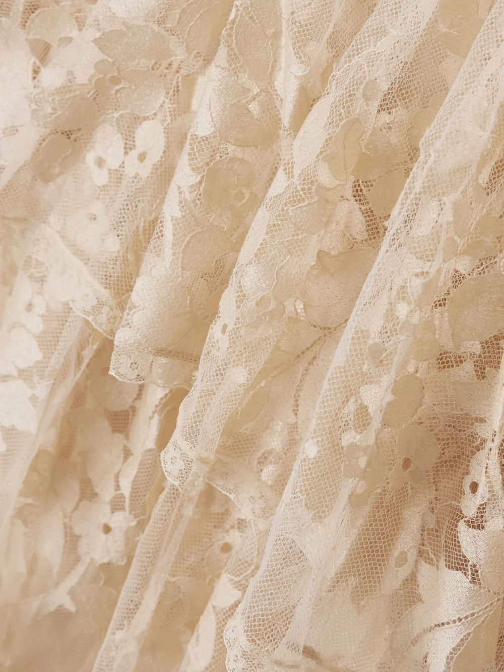 Close-up detail of the Zimmermann Illustration Open-back Tiered Pleated Cotton-blend Lace Halterneck Mini Dress
