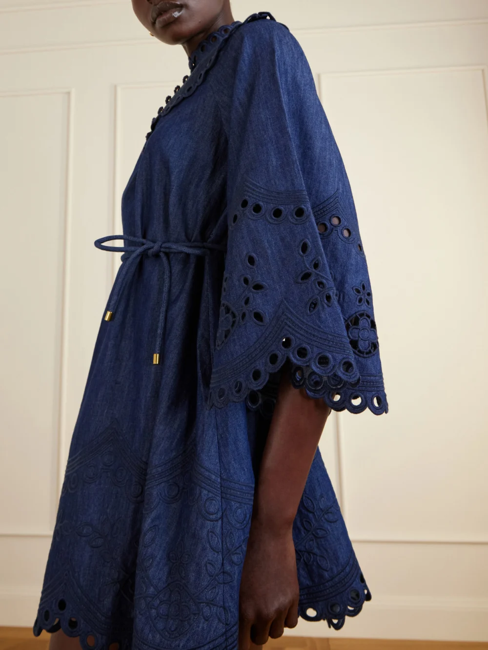 Close-up detail of the Zimmermann Mahon Broderie Anglaise Denim Mini Dress
