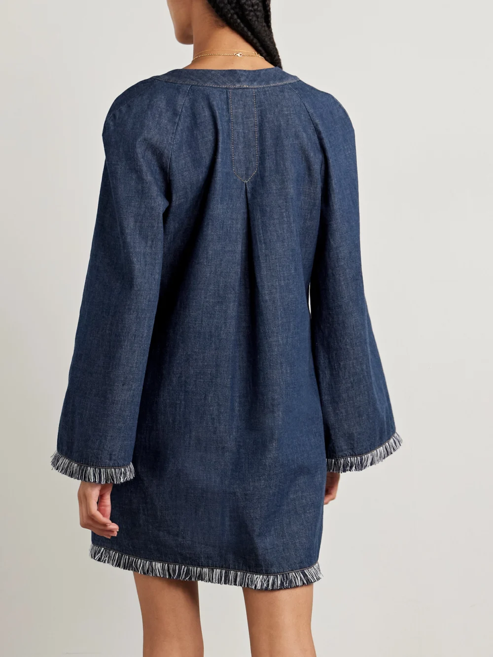 Back view of the Zimmermann Rhiannon Tie-detailed Frayed Denim Mini Dress