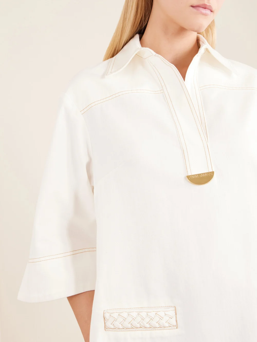 Close-up detail of the Zimmermann Roselight Paneled Denim Mini Dress