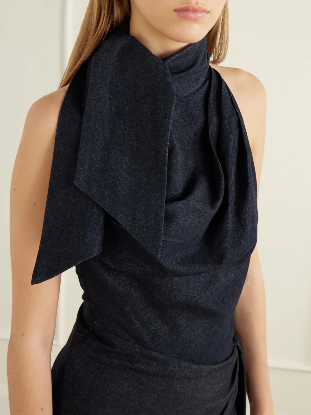Close-up detail of the Zimmermann Valiant Open-back Asymmetric Draped Denim Maxi Dress