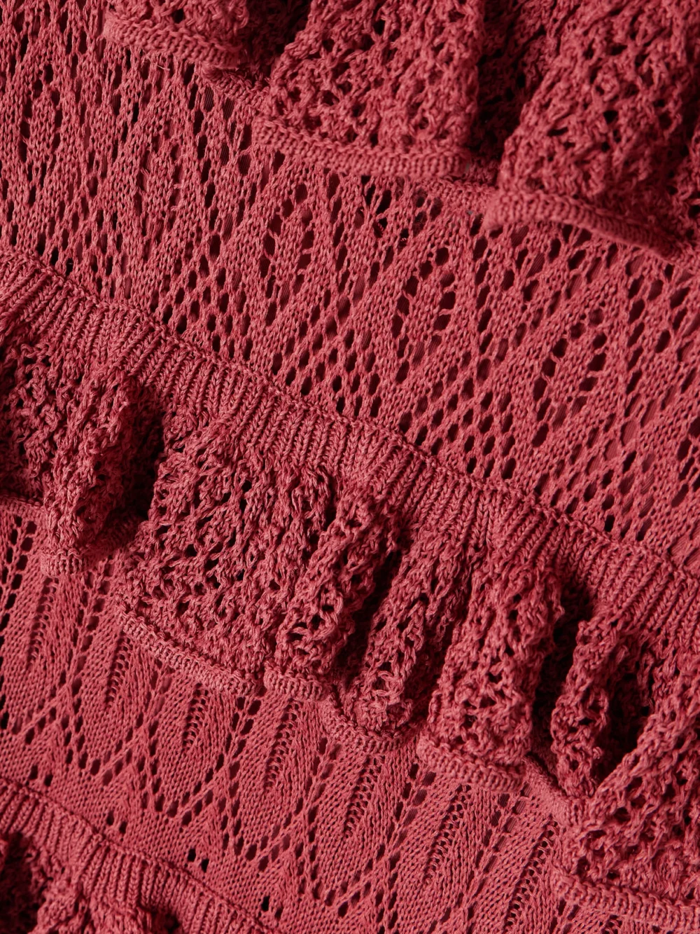 Close-up detail of the Zimmermann Wanderlust Ruffled Open-knit Maxi Dress