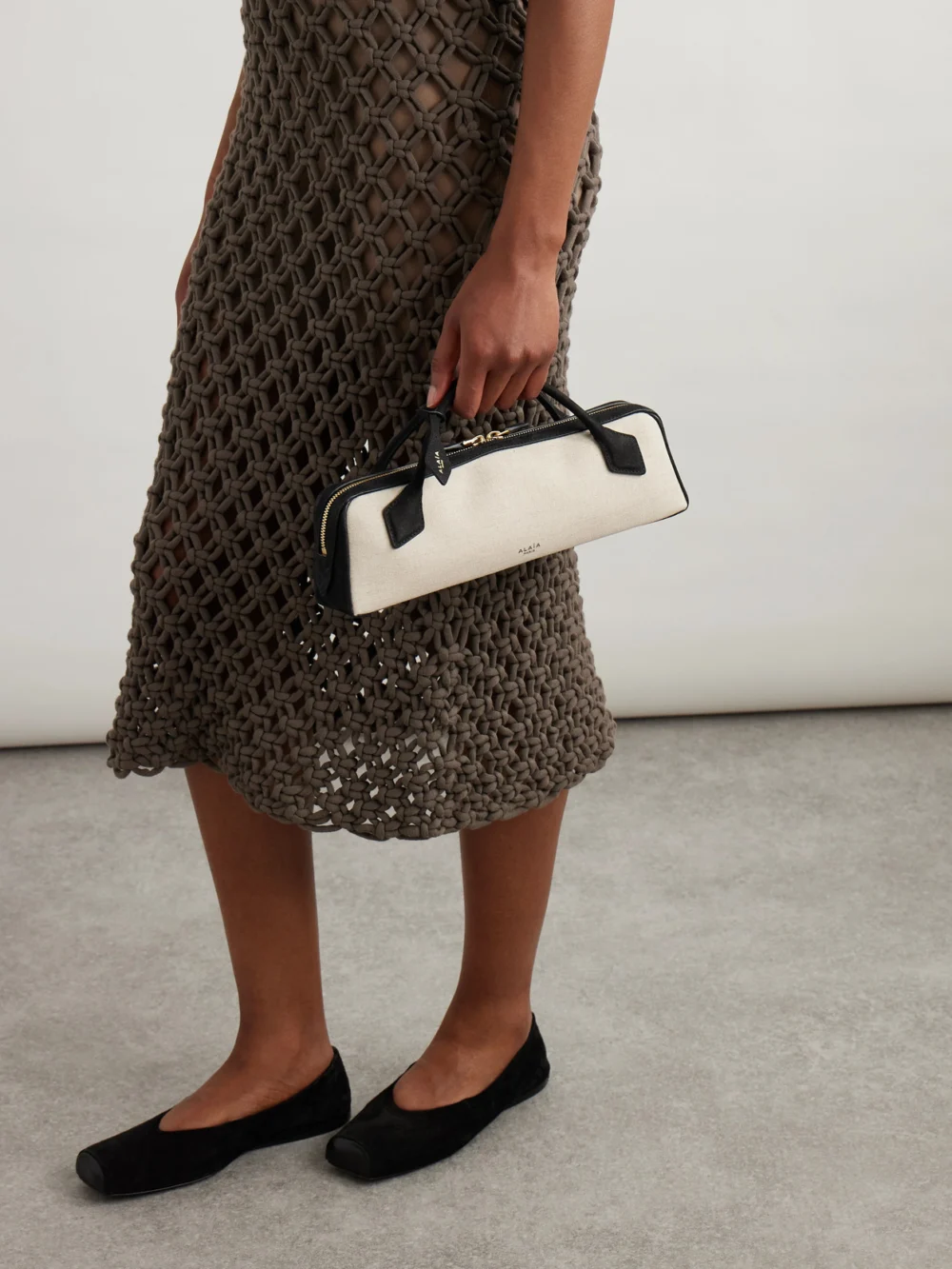 Alaïa Le Teckel Leather-trimmed Canvas Clutch, styled view