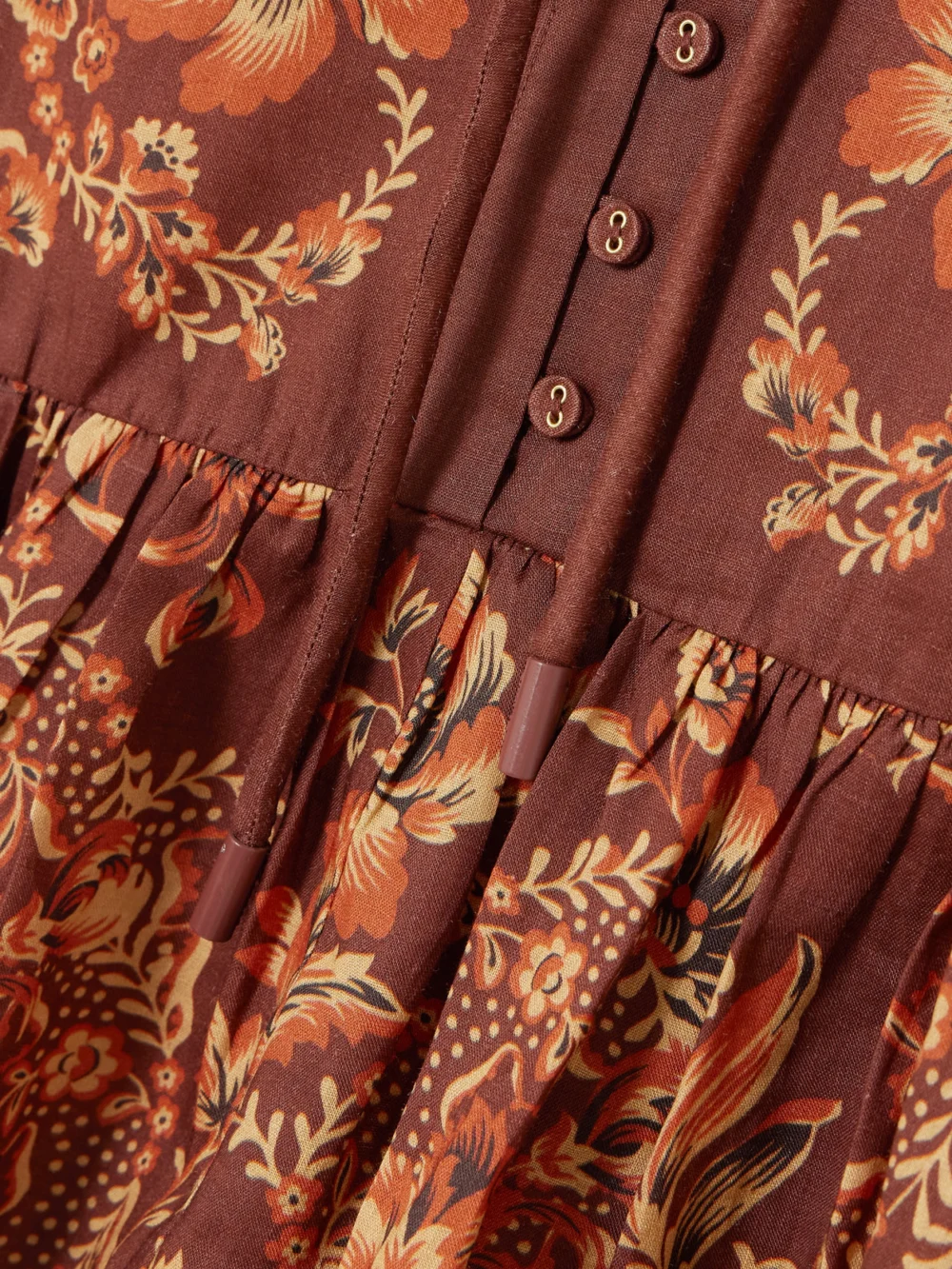 Close-up detail of the Alémais Seraphina Belted Tiered Printed Ramie Mini Dress