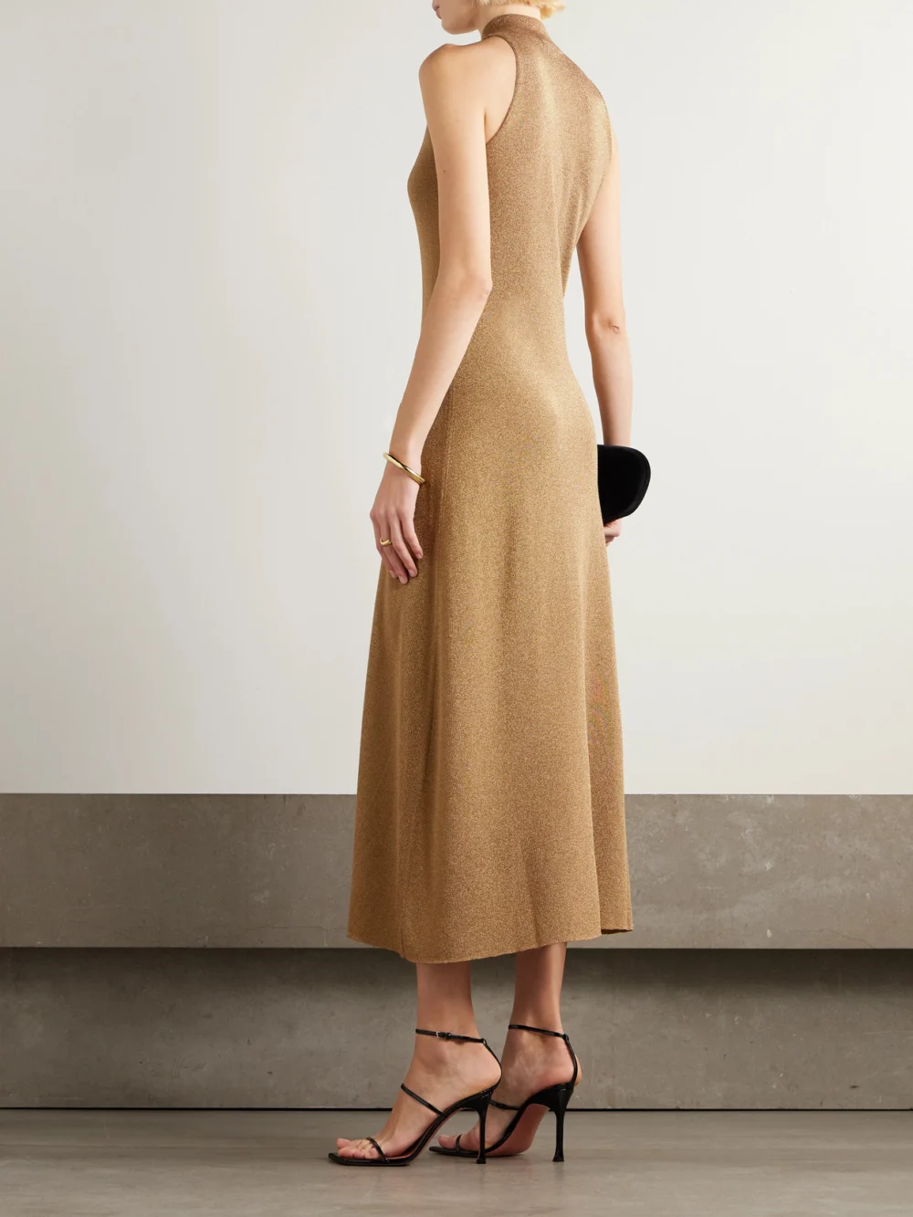 Back view of the Altuzarra Mitzi Metallic Knitted Turtleneck Midi Dress