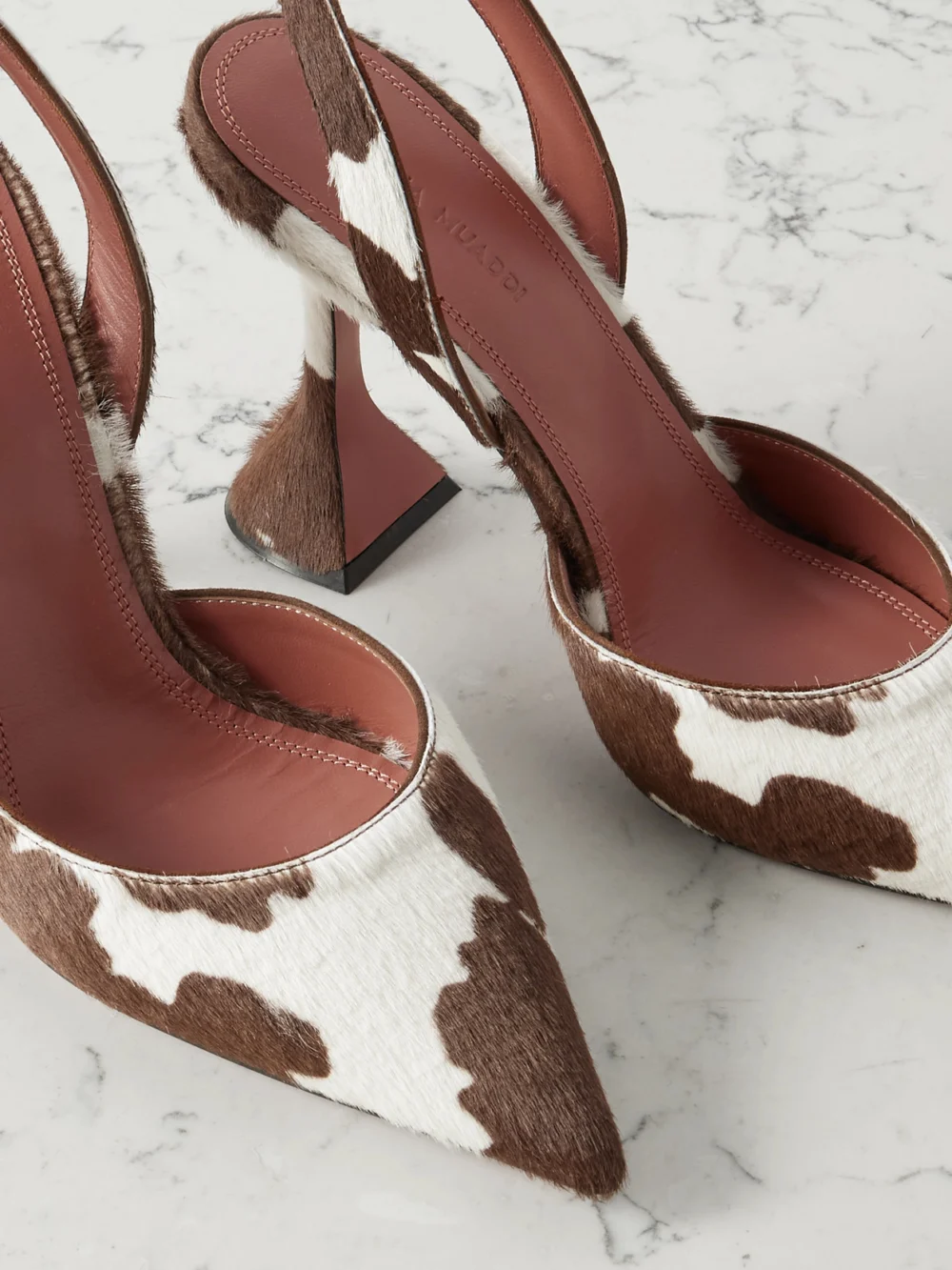 Close-up detail of the Amina Muaddi Holli 95 Cow-print Calf Hair Slingback Pumps