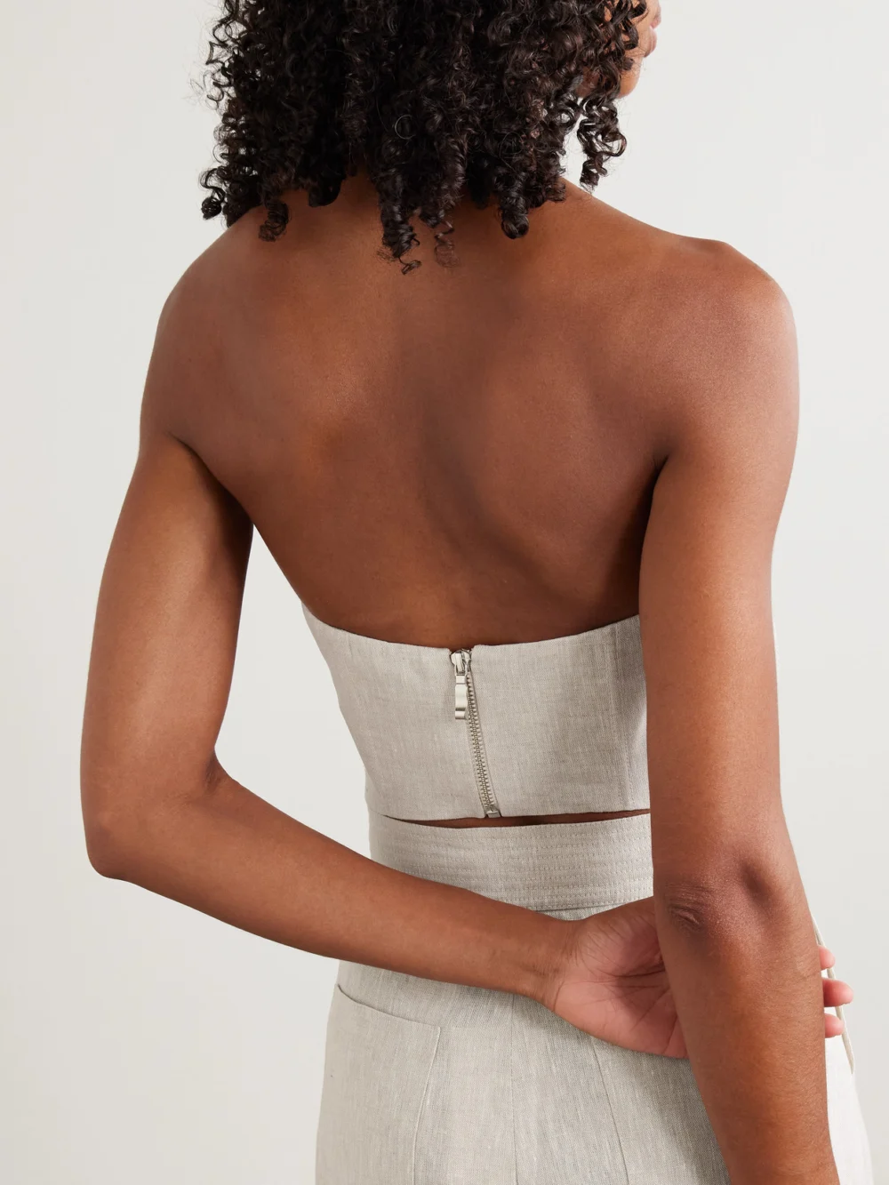 Back view of the Andres Otalora Cropped Appliquéd Topstitched Linen Bustier Top