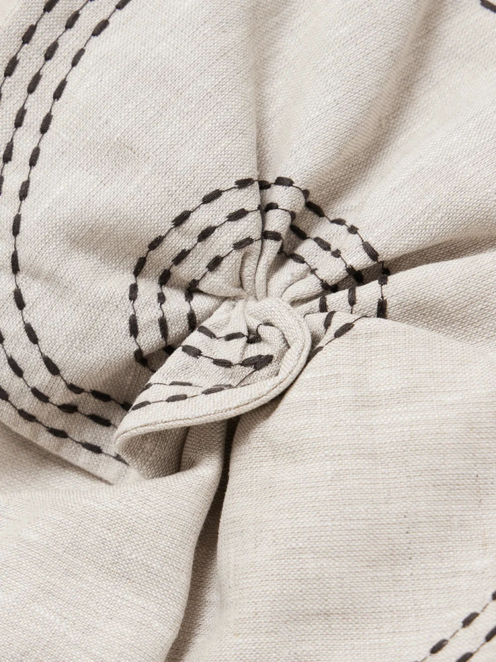 Close-up detail of the Andres Otalora Cropped Appliquéd Topstitched Linen Bustier Top