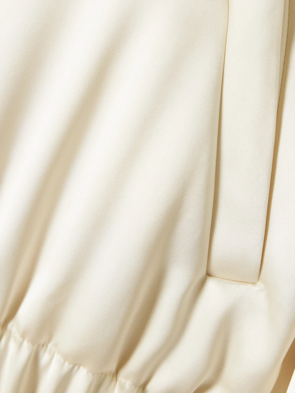 Close-up detail of the Another Tomorrow Cropped Satin Bomber Jacket