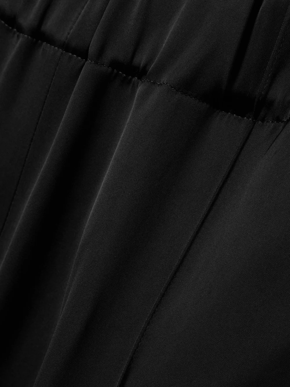 Close-up detail of the Another Tomorrow Pleated Satin Straight-leg Track Pants